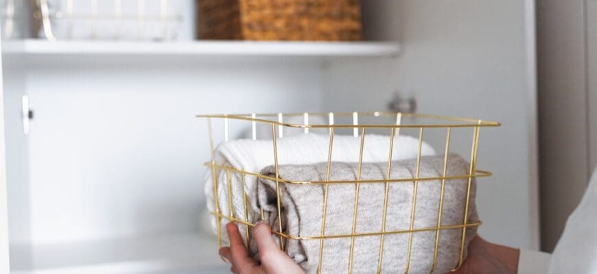 Woman,Organizing,Clothes,On,Shelves,In,White,Opened,Wardrobe,,Folding